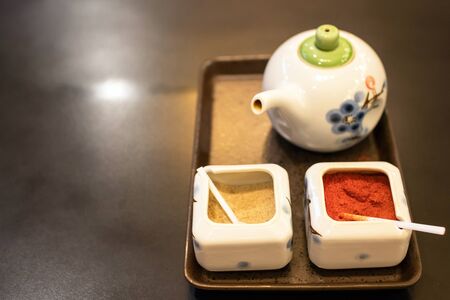 Seasoning set Japanese tableware shoyu sauce and ground cayenne pepper on table at Japanese...