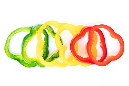 Stack of bell pepper slices isolated on white background.の写真素材