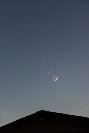 Crescent moon close approach to star. Earthshine is a soft, faint glow on dark side of moon; occurs...