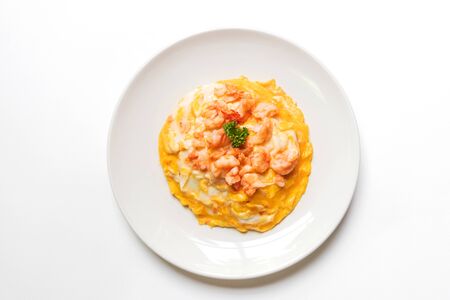 Creamy omelette with shrimps on rice isolated on white background. Delicious and easy menu.の写真素材