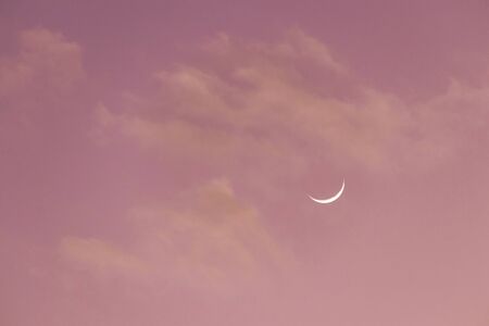 Crescent moon on sweet sky. Look like a smile on a good day.の写真素材