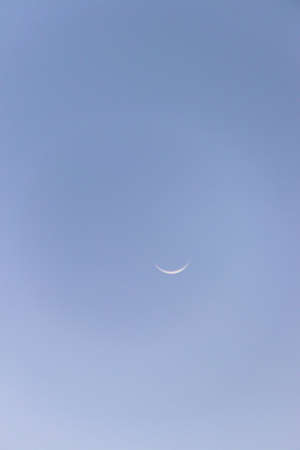 Crescent moon on blue sky. Look like a smile on a good day.