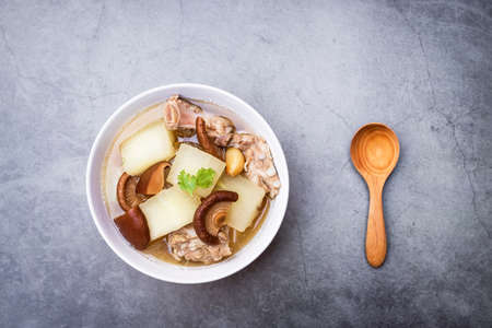 Winter melon soup with pork rib and shiitake mushroom with herbs (Thai clear soup with vegetable).の写真素材