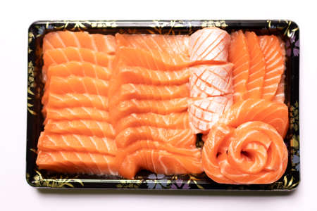 Fresh salmon sashimi serve on take a way tray isolated on white background.