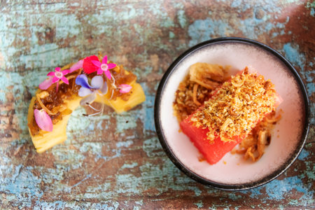 Sweet and sour fruit (pineapple) slices served with a nutty, sweet-savory peanut sauce called Mahor and Watermelon with sweet dried fish crispy shallot dip; traditional Thai snack, Royal Thai Canape.の写真素材