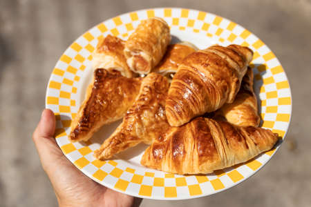 Delicious puff pastry and croissant on dish; ready to serve.の写真素材