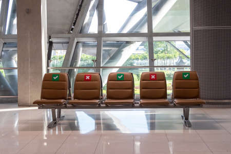 Social distancing chairs in airport during virus outbreak a new normal concept.