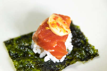 Pickled salmon with soy sauce served seaweed, rice, green vegetables and spicy sauce. Korean food...
