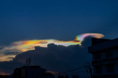Beautiful iridescent cloud, Irisation. Skyscraper background.の写真素材