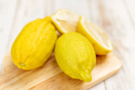 Eureka lemon on wooden table background.