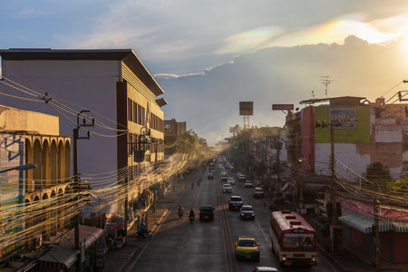 Nonthaburi, Thailand - September, 2021: Pracharat road with many buses and cars on the road in the evening with beautiful iridescent cloud on the sky.のeditorial素材