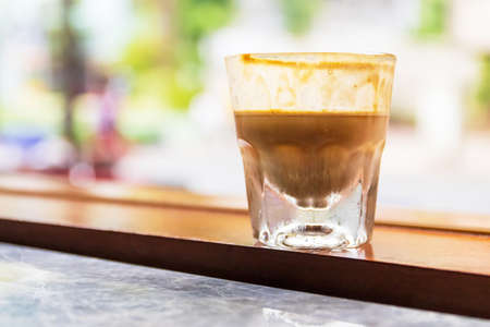 Specialty coffee menu; Dirty coffee is ristretto pouring from coffee machine into cold milk.の写真素材