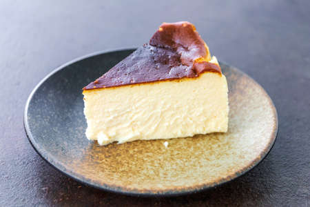 Piece of Basque Burnt Cheesecake on plate.の写真素材