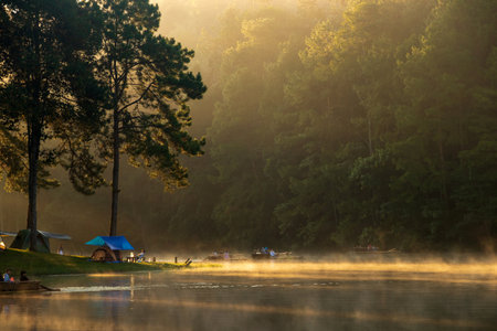 Mae Hong Son, Thailand-Oct, 2021: Bamboo rafting at PangUng Lake in Mae Hong Son, north of Thailand. Floating in the water and cuddled by mild fog and gentle light of the sunlight in the morning.のeditorial素材