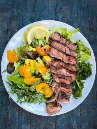 Grilled beef with healthy salad on white plate; top view.の写真素材