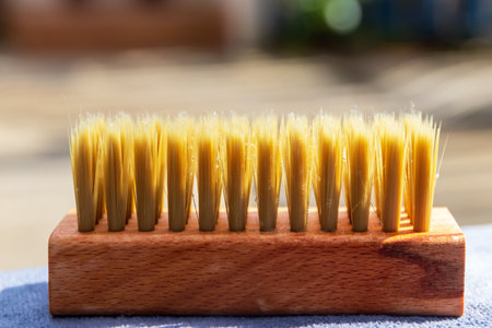Wooden clothes hand brush with warm sunlight for manual cleaning of clothes and shoes.の写真素材