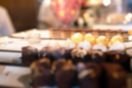 Blurred image for background of pastry showcase in cozy cafe background.の写真素材