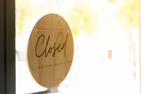 Sign of Closed and Please come again later wording on wooden board.の写真素材