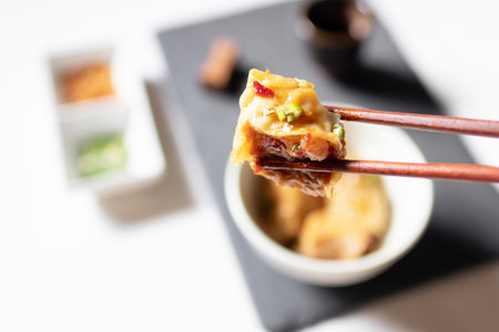 Steamed dumpling stuffed ground shrimp and pork dipping sweet chili sauce with fried garlic and spring onions.の写真素材