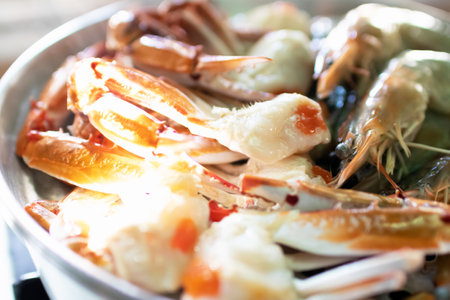 Steam blue crab legs and shrimp on food steamer.の写真素材