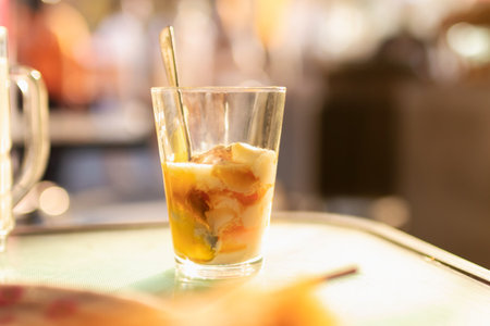 Soft-boiled eggs in glass with seasoning sauce and ground pepper; Thai breakfast vintage style.の写真素材