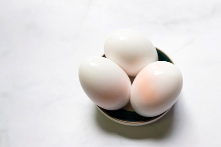 Boiled eggs on white table background.