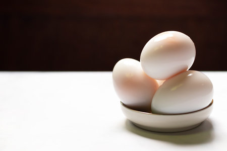 Boiled eggs on white table background.の写真素材