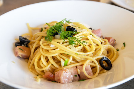 Spaghetti with guanciale, garlic, olive oil and chili on white plate.の写真素材