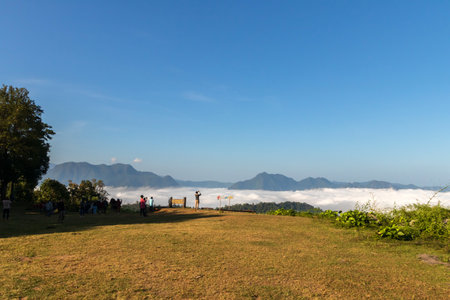 Mon Kcru Ba Sai scenic point. (View point at Mon Kcru Ba Sai words on wooden board) from top of a mountain with the beautiful sea of mist, Mae Moei National Park, Tak in Thailand.の写真素材