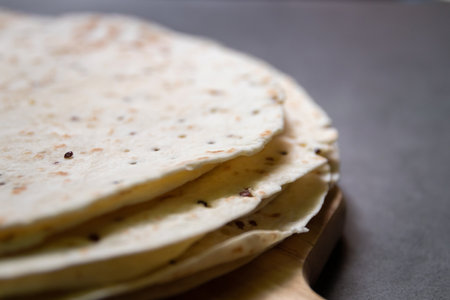 Stack of tortillas with the super-food quinoa on grey background.の写真素材