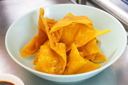 Deep fried wonton in a blue bowl.の写真素材