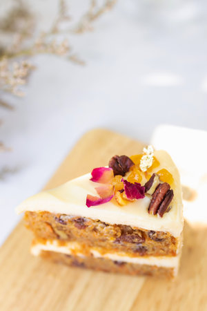 Piece of cake with pecan and raisins on topの写真素材