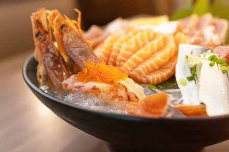 Japanese sashimi set serve on ice with warm light at japanese restaurant.の写真素材