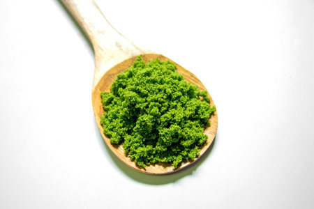 Wolffia globosa in wooden spoon isolated on white background. Wolffia is the nutrient-rich plant-based source of protein and omega3 and vital minerals like zinc, calcium, iron, B12の写真素材