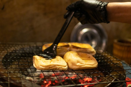Toast buns on a grill. Old-school butter bun charcoal grill.の写真素材