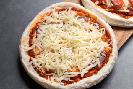 Delicious gourmet pizza with cheese on black table background. Homemade delicious pizza.