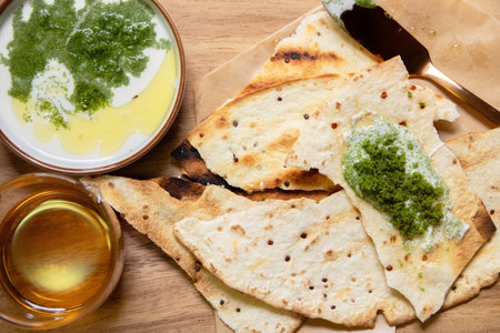Vegan recipes with tortillas and wolffia spread on wooden plate. Wolffia is the nutrient-rich...