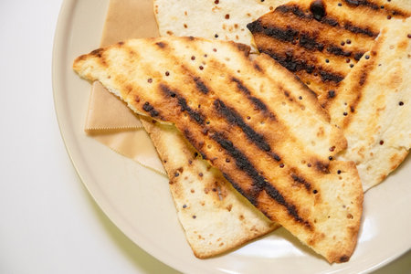 Close-up of a plate with toasted bread on white backgroundの写真素材