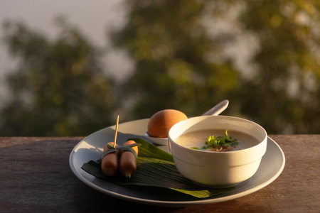 Breakfast table on rustic wooden terrace with fog on mountains in morning sunrise background.の写真素材
