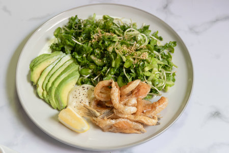 Green salad and avocado with fried toro salmon. Healthy and balanced menu.の写真素材