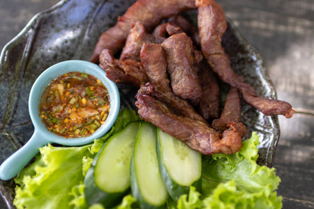 Thai fried beef jerky with Thai spicy dipping sauce (Jaew sauce).の写真素材