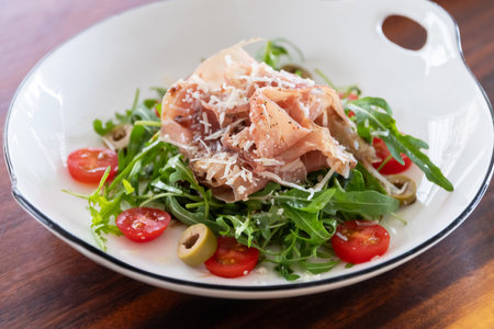 Parma ham and mozzarella with rocket, extra virgin olive oil and balsamic vinegar salad.の写真素材