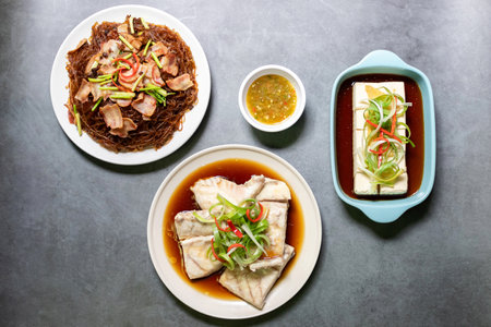 Sea bass fillet steam with soy sauce, shrimp potted with vermicelli and vegan silken tofu is served...