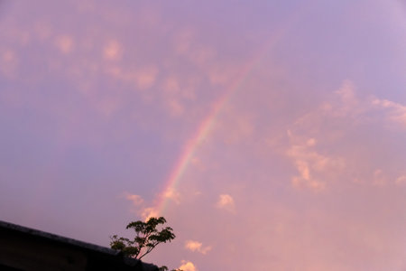 After the rain. The sky is clearing up and a rainbow is forming.の写真素材