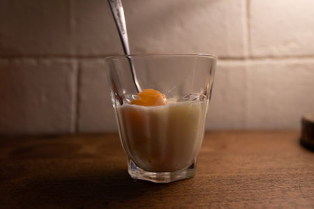 A glass of milk with soft-boiled egg.の写真素材