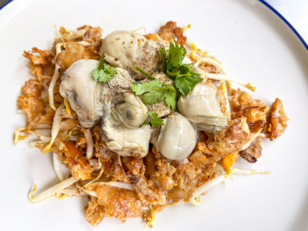 Asian delicious fried seafood with eggs omelette, popular cuisine food in asia.の写真素材