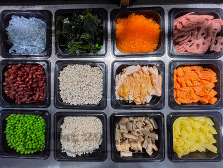An assortment of colorful ingredients neatly arranged in containers, perfect for meal preparation or culinary presentations.の写真素材