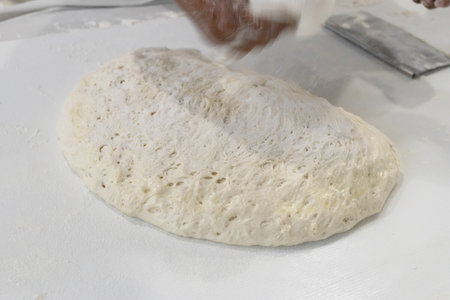 Fresh dough preparation on a kitchen surface.の写真素材