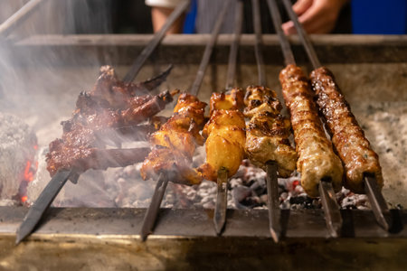Delicious skewers grilling over hot coals.の写真素材