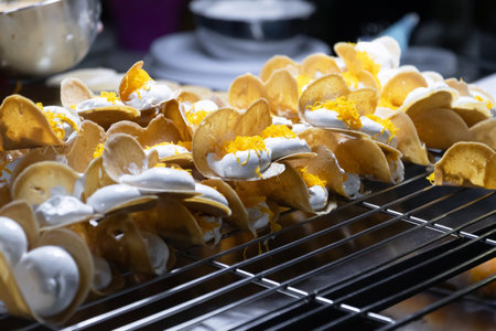 A hand crafting traditional snacks. Khanom Beaung or a kind of filled pancake Thai dessert; Thai...